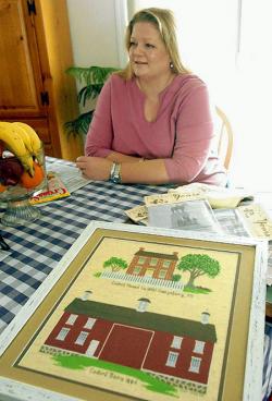 Kristiina Frost creates her Historically Yours cross-stitch patterns on her home computer in Washoe Valley. The piece in front of her is of the Codori House, circa 1854, and the Codori Barn, circa 1884, in Gettysburg, Pa. - Lisa J.Tolda/RGJ